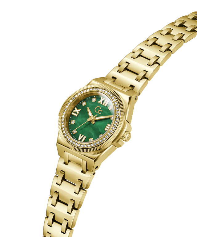 Gold-tone women's watch with a green dial, crystal gemstone bezel, and gold link bracelet, shown on a plain white background. lifestyle