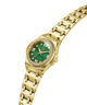 Gold-tone women's watch with a green dial, crystal gemstone bezel, and gold link bracelet, shown on a plain white background. lifestyle