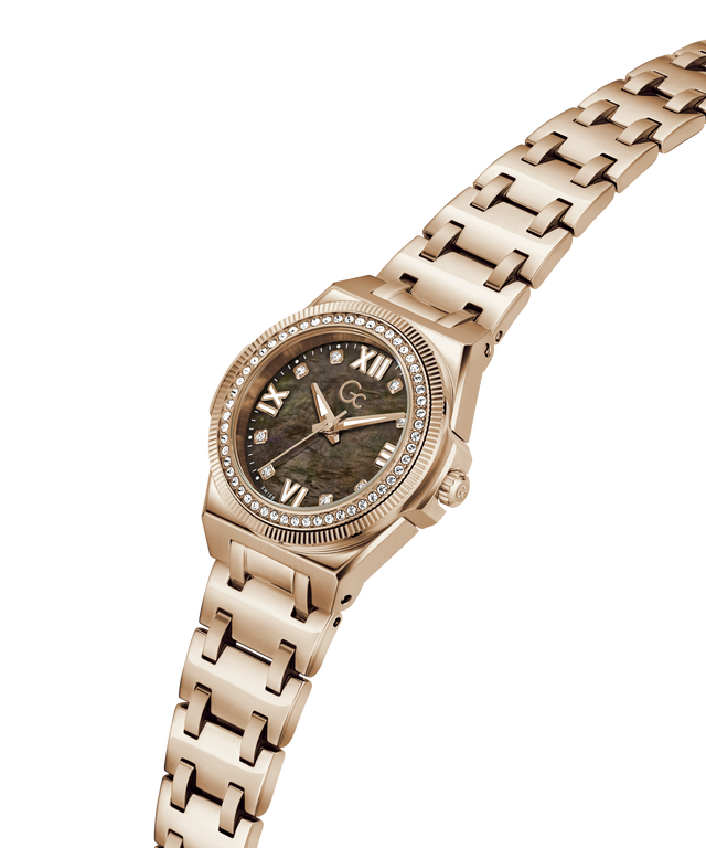 A rose gold women's watch featuring a textured green mother-of-pearl dial, a crystal-accented bezel, and a matching rose gold link bracelet, shown on a plain white background. lifestyle