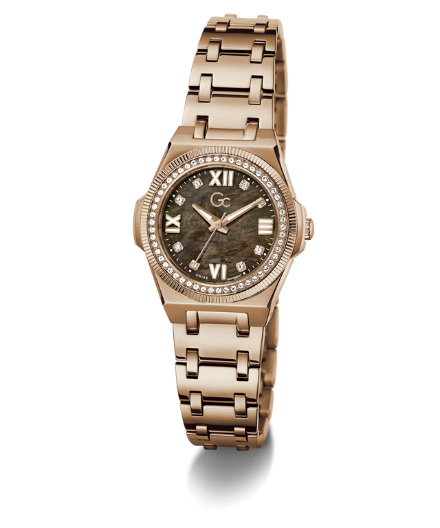 A women's rose gold-tone stainless steel watch with a round dial featuring a dark mother-of-pearl pattern, Roman numeral hour markers, a crystal gemstone bezel, and a matching rose gold link bracelet.