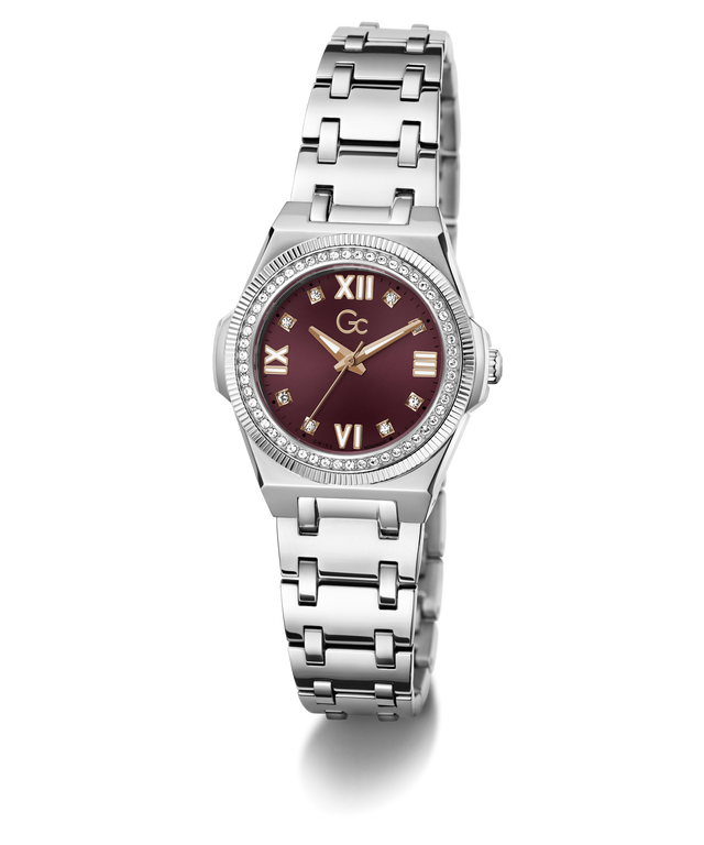 A women's stainless steel watch featuring a round silver-tone case, a bezel set with small clear crystals, a silver-tone link bracelet, and a deep burgundy dial with Roman numerals and gold-tone hands.