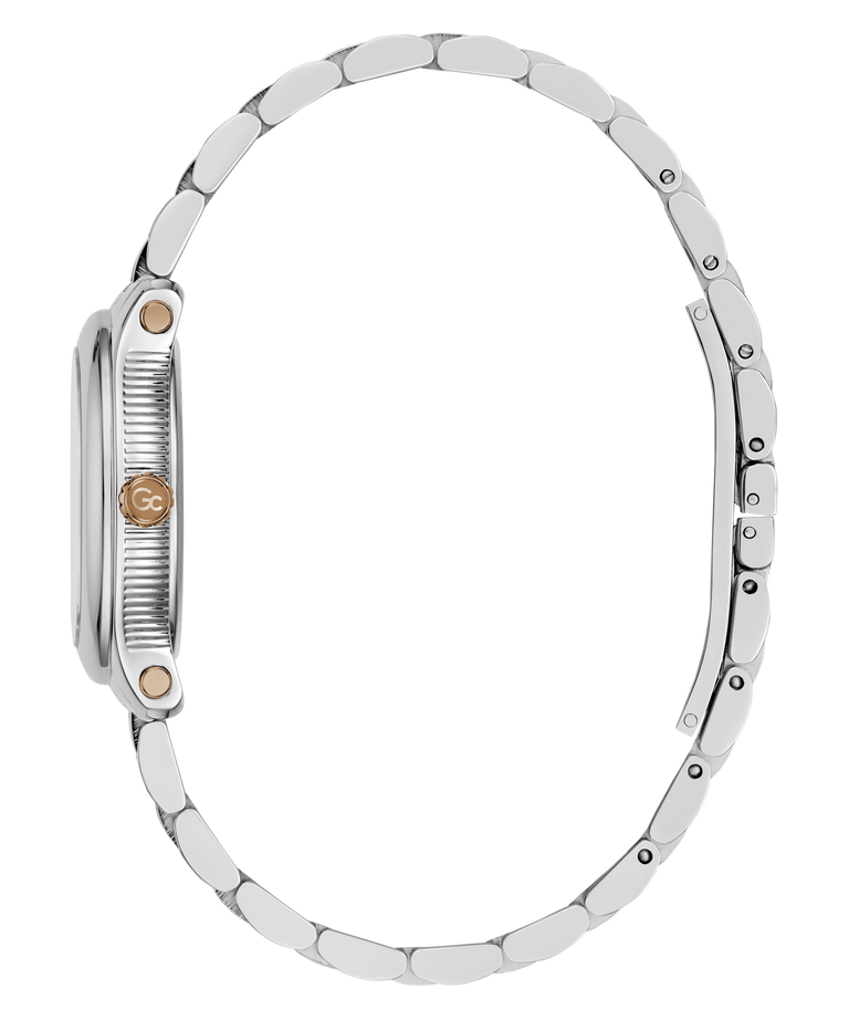 Close-up side view of a silver-tone metal watch with a matching link bracelet, featuring a textured crown guard and a small round rose gold accent on the side.