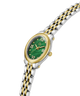 A women's oval watch with a two-tone silver and gold stainless steel link bracelet, a gold bezel, and a green dial with gold Roman numerals. lifestyle