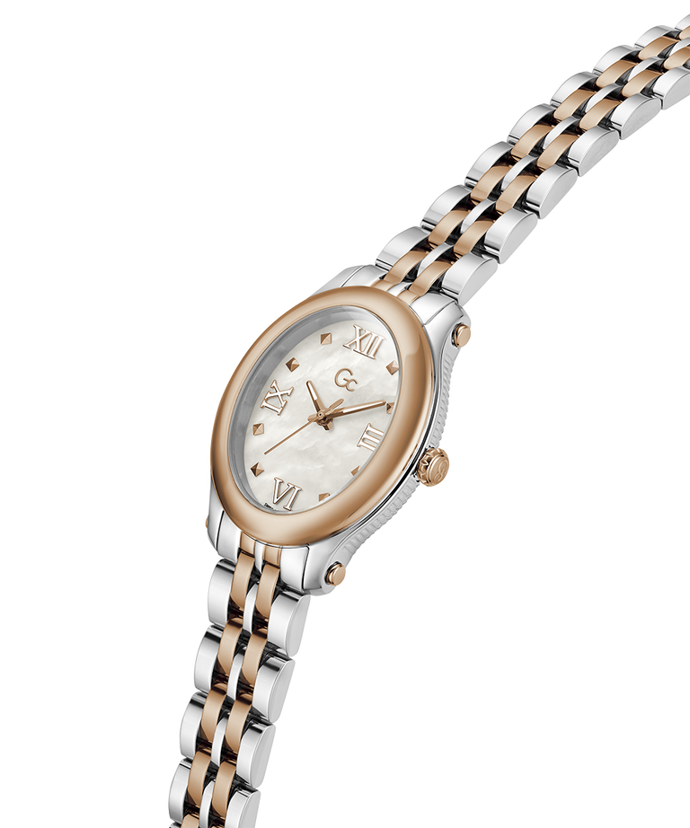 A two-tone oval wristwatch with a silver and rose gold metal link bracelet, a rose gold bezel, and a white dial with Roman numeral hour markers. lifestyle