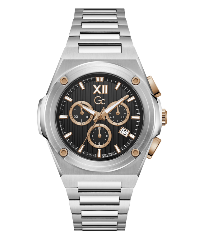A luxury chronograph watch with a brushed silver-tone metal case and integrated link bracelet, featuring a black dial with gold-tone subdials, Roman numeral XII, and a date window.