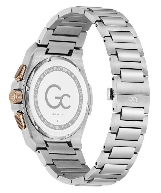 The back view of a Gc men's watch featuring a brushed stainless steel case and integrated link bracelet, with a gold-tone crown and pushers.