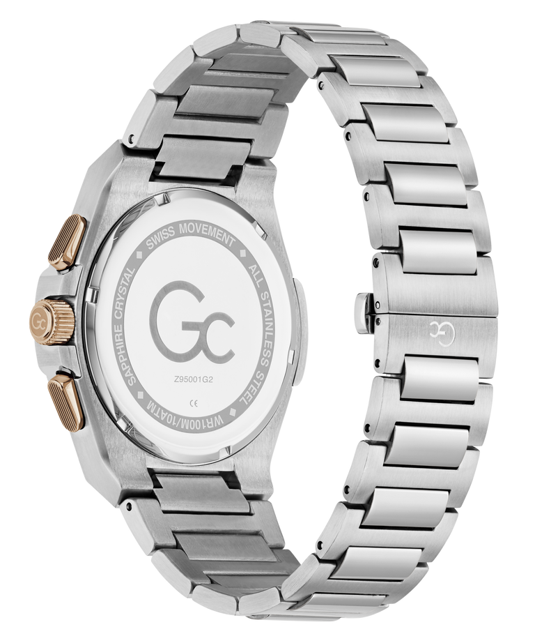 The back view of a Gc men's watch featuring a brushed stainless steel case and integrated link bracelet, with a gold-tone crown and pushers.