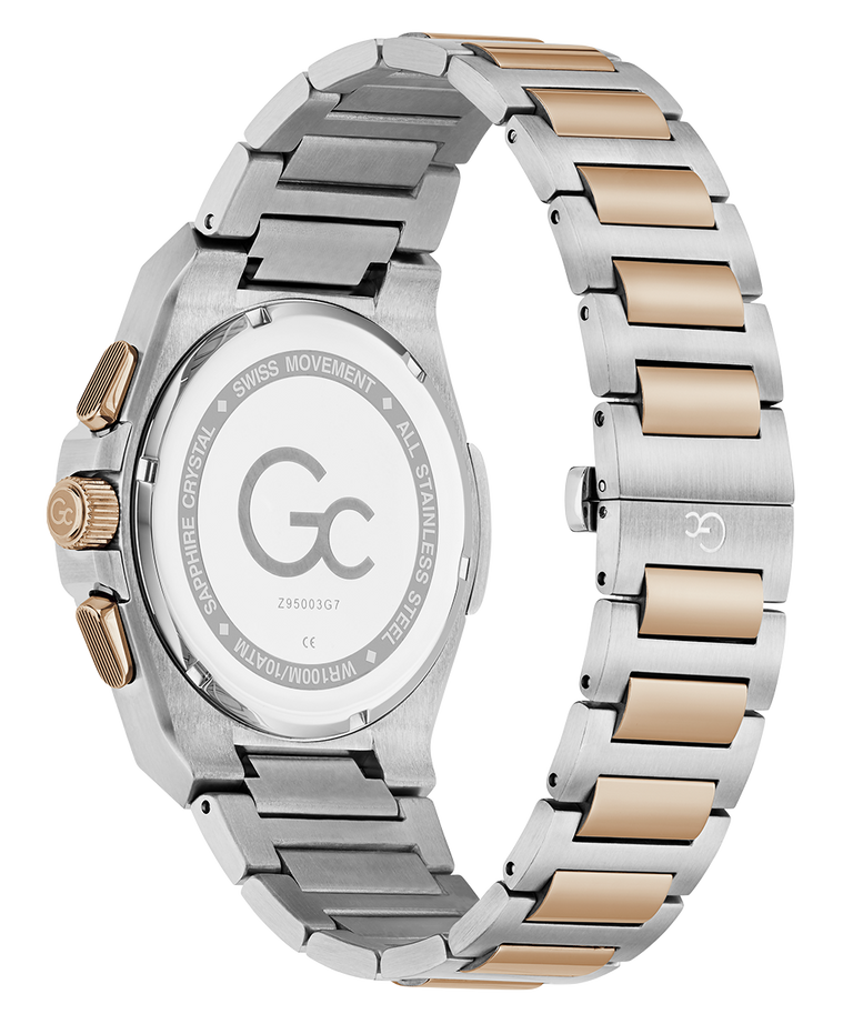 A close-up rear view of a wristwatch with a two-tone stainless steel and rose gold link bracelet, showing the engraved back case and crown.