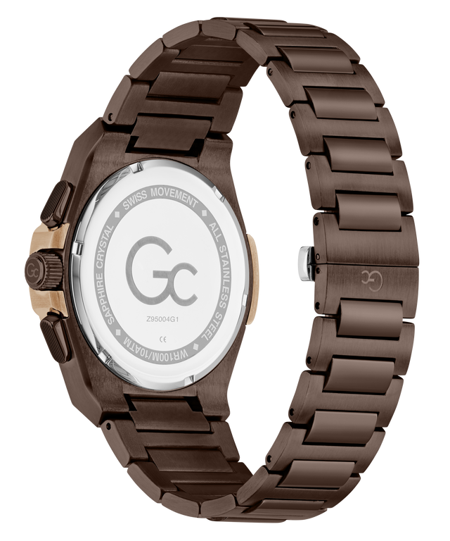 A close-up of a men's watch showing the back of the case and metal link bracelet. The watch has a dark brown anodized metal bracelet and case, with a rose gold-tone crown adjustment on the side.