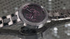 ladies silver watch with glitz on a glitz background with pink logo dial
