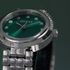 Exude elevated elegance with this beautifully crafted timepiece! This pretty 28 mm silver case showcases asymmetrical crystals on its bezel and is paired with a unique and beautiful bead-textured polished recycled steel silver bracelet. An emerald green sunray dial ties the look together! video