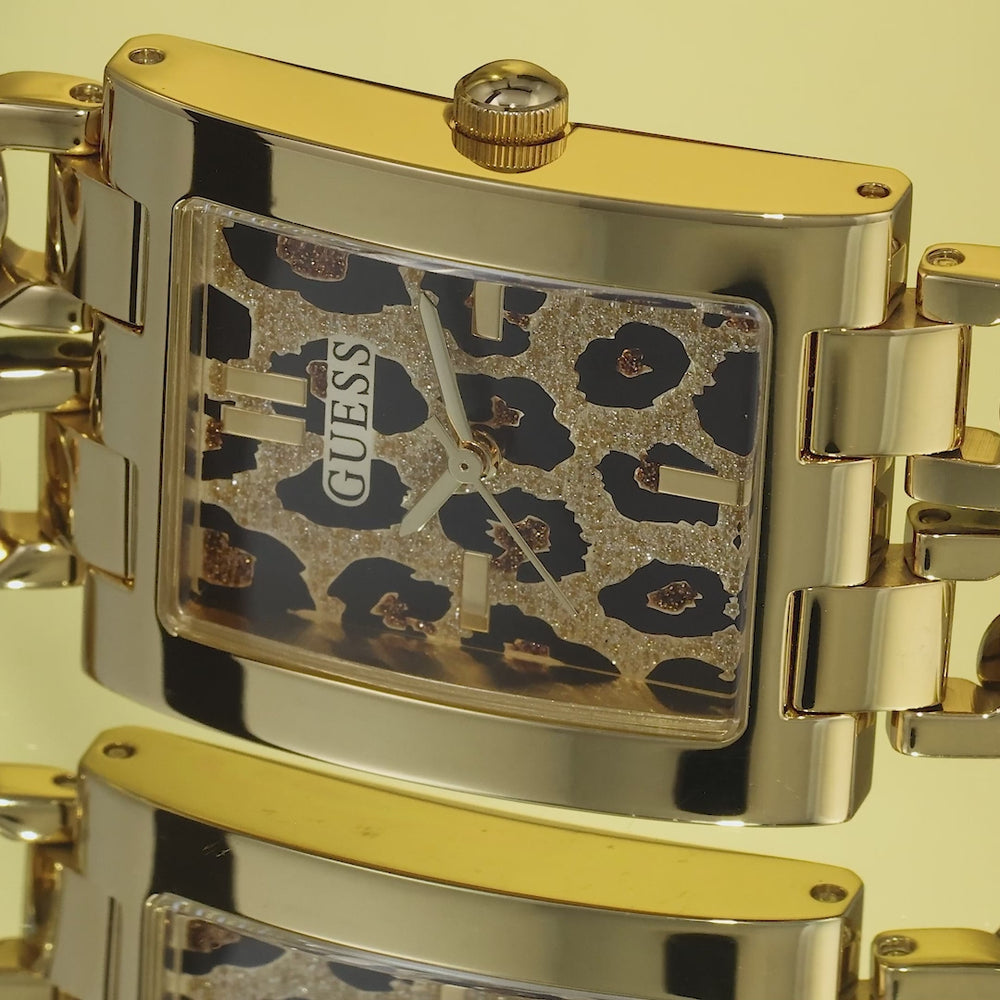 video featuring gold watch with animal patterned dial