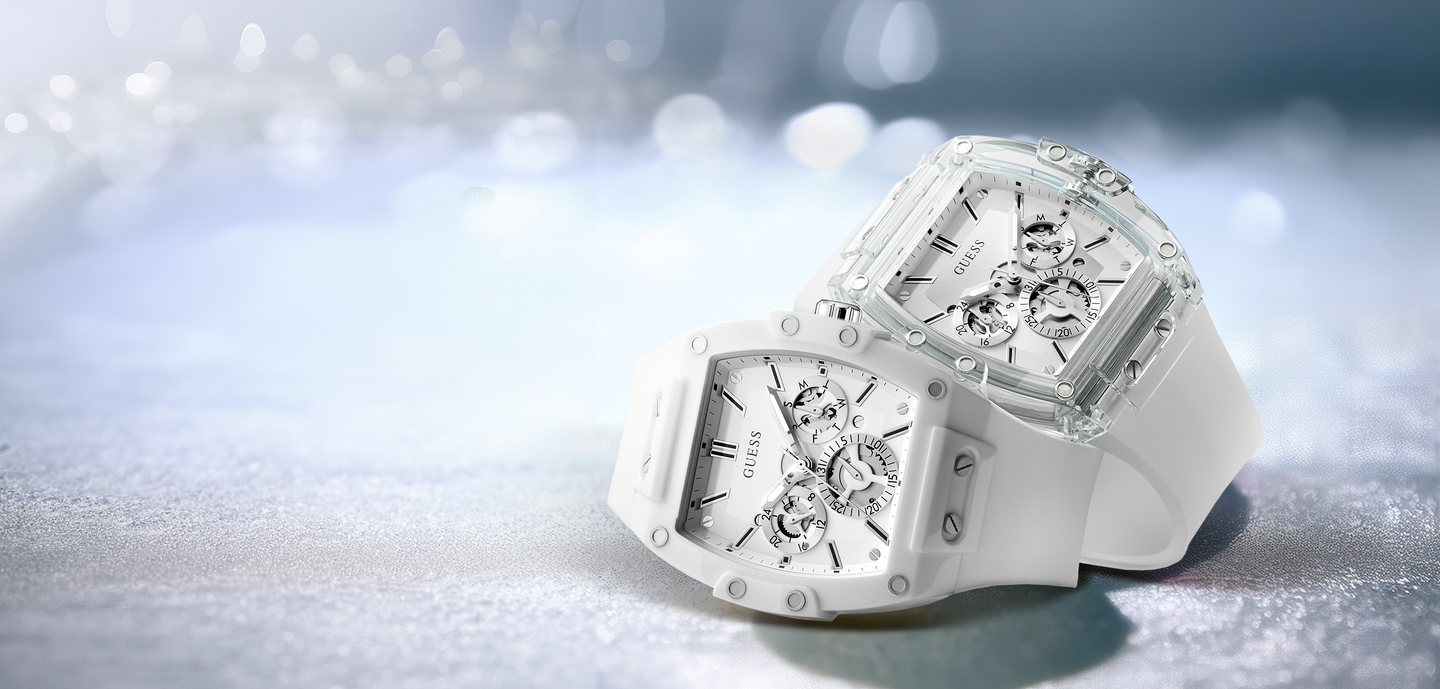 Two white mens watches on a sparkly background